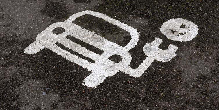 A painted sign on the road: EV charging point.